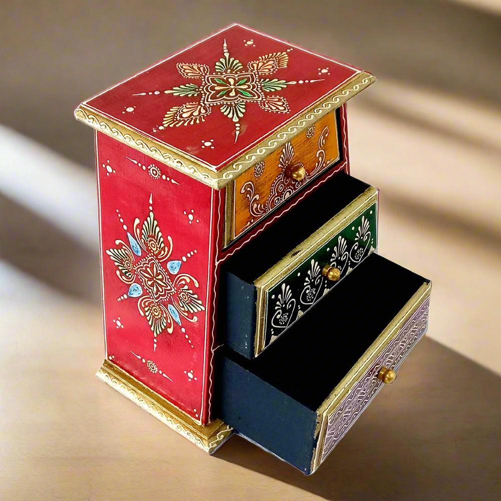 A hand-painted 3-drawer storage organizer, useful for keeping small items like earrings, pens, and markers.