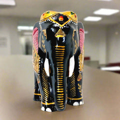 A hand-painted elephant figurine made from fine quality Kadamba wood, perfect for gifting.