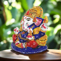 Small metal Ganesha idol with intricate blue, red and white meenakari hand painting, suitable for gifting and home decor
