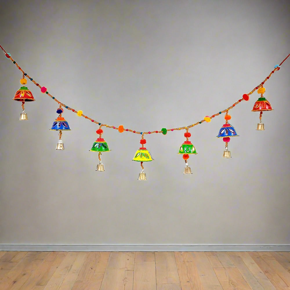 A colorful, hand-painted papermache Bandarwal with cute round bells and pom-poms.