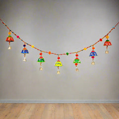 A colorful, hand-painted papermache Bandarwal with cute round bells and pom-poms.