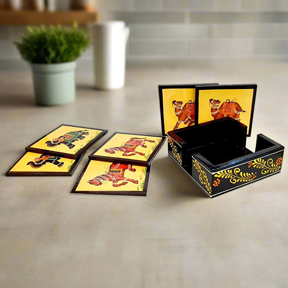 Top view of 6 pcs Rajasthani wooden coaster set, elephant horse camel motifs in hand painting – traditional wood gift item.