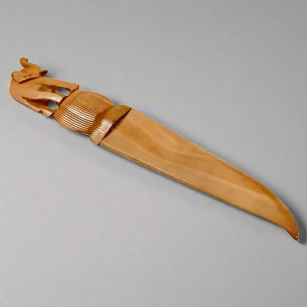 Handcrafted wooden paper cutter with a detailed elephant design carved on the handle for office use.