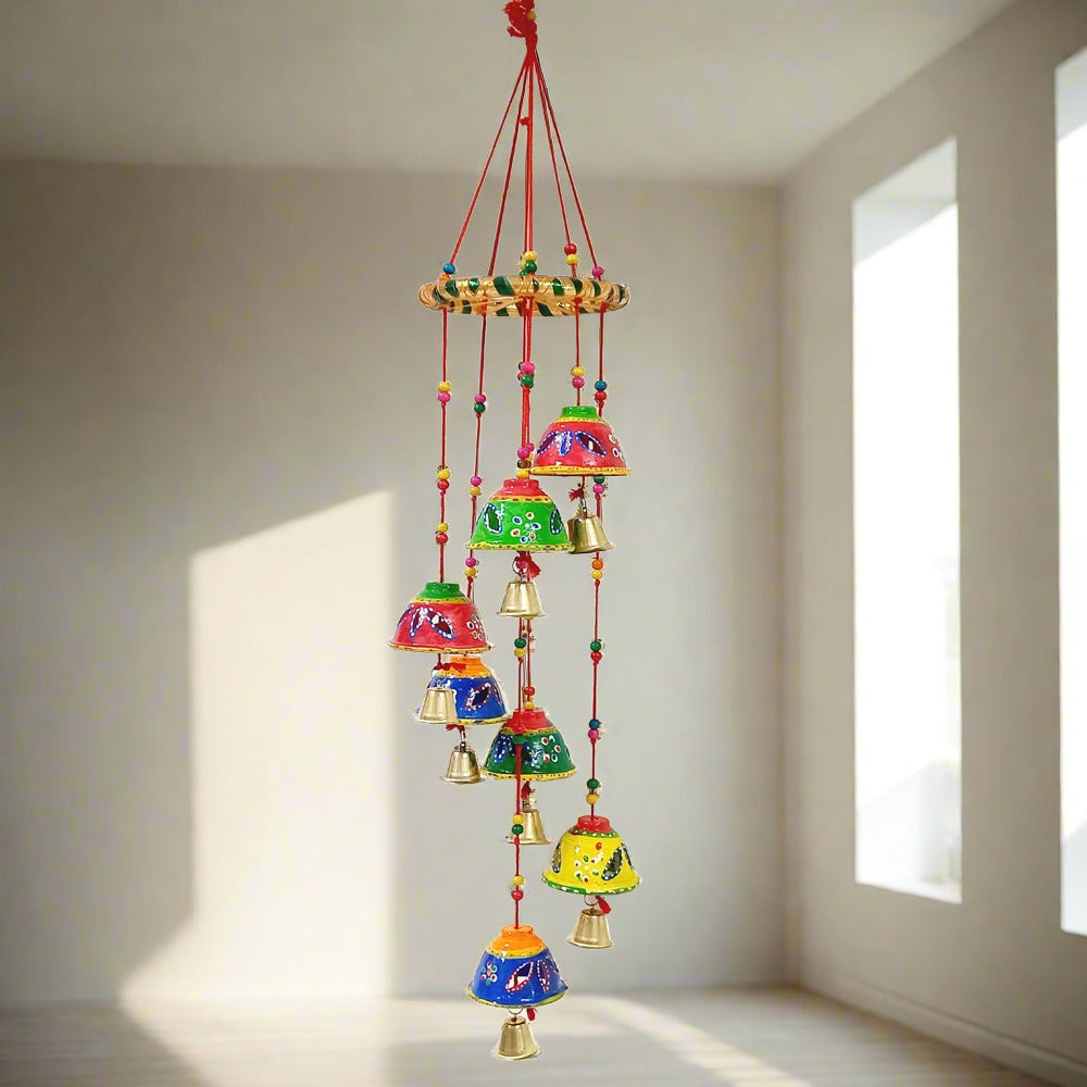 A beautiful handmade jhumar toran made with papermache, beads, and brass bells.