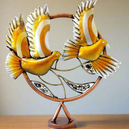 A handcrafted metal bird statue, perfect as a piece of wall art or for gifting.