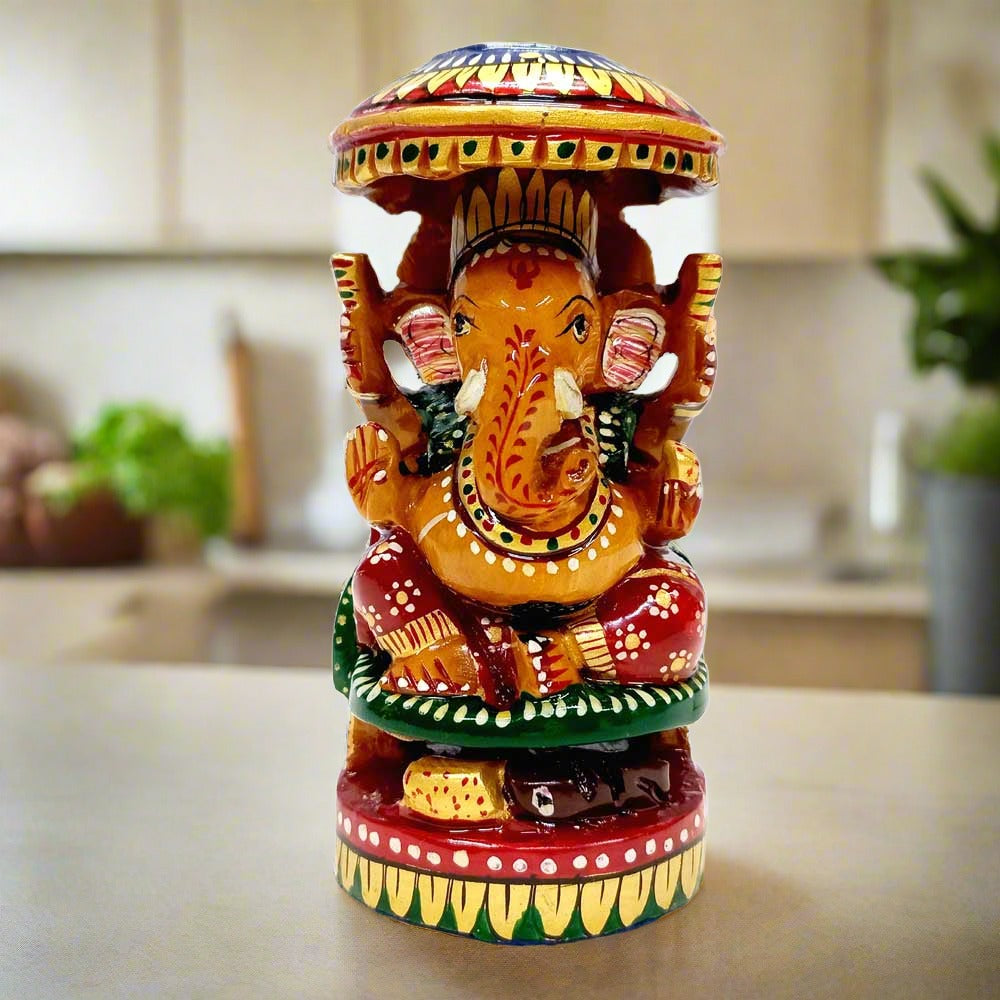 Handmade wooden Ganesha idol with round shape and umbrella design, featuring fine hand painting