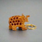 A handmade wooden key chain with an elephant design, perfect for car, bike, and wardrobe keys.