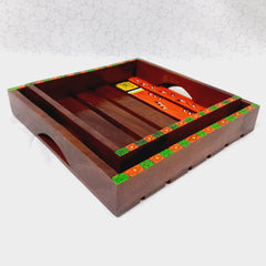 Handmade wooden trays with traditional art, set of two, enhancing kitchen and dining table aesthetics.