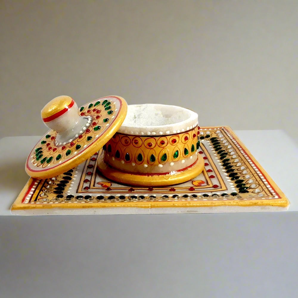 Hand-painted marble container with tray featuring kundan embellishments, ideal for dry fruits or saffron at weddings.