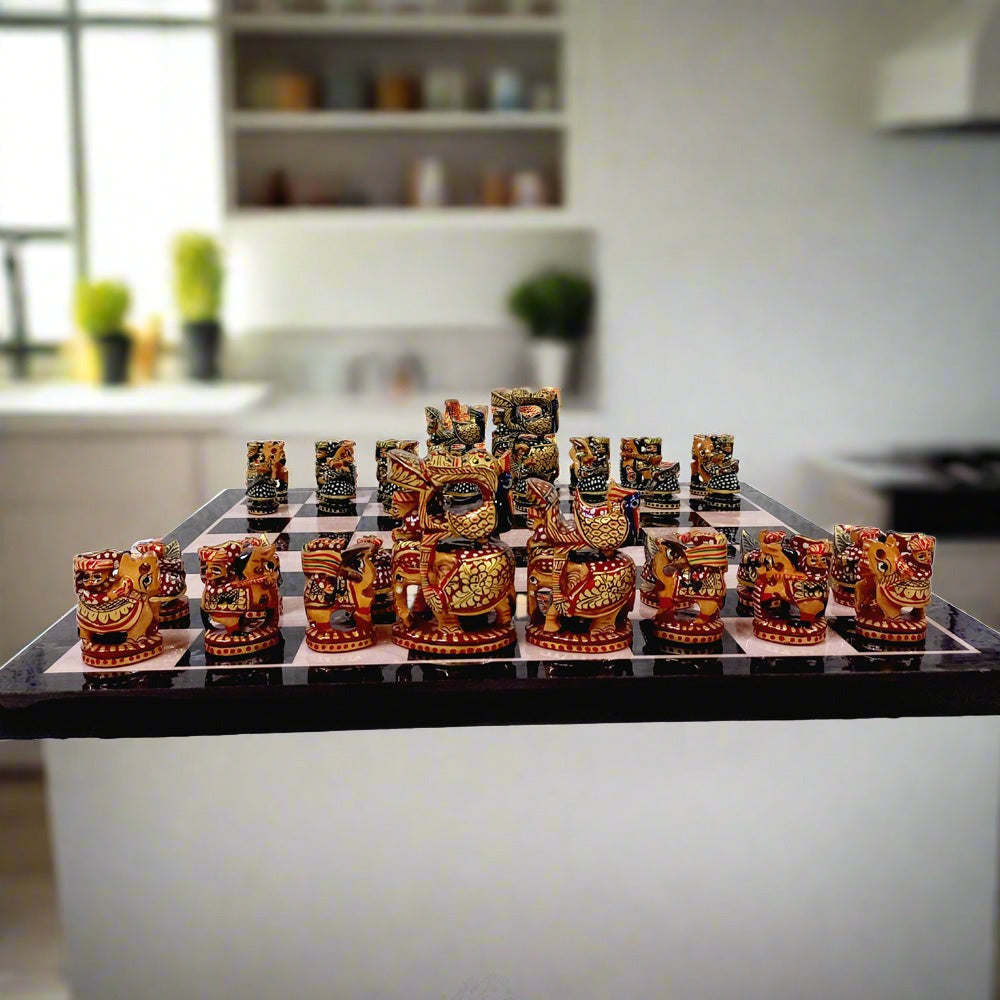 Hand-painted wooden chess set with red and green color theme, showcasing traditional Indian craftsmanship.

