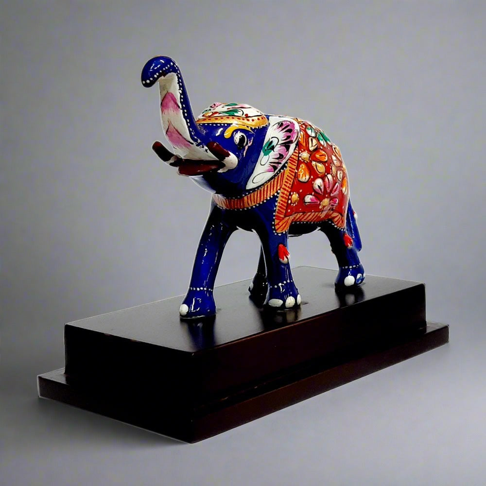 Side view of multicolour emboss meenakari elephant on wooden platform.
