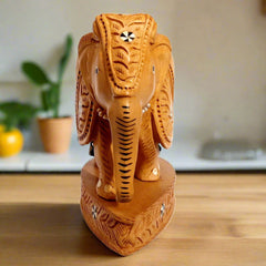Closeup of exquisite inlay patterns on premium Kadamb wood elephant.