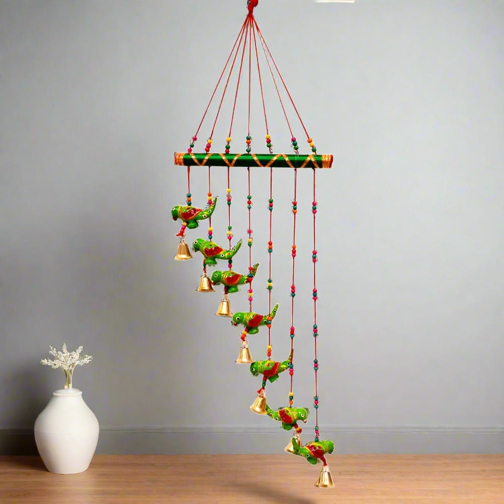 Interior decor papermache parrot toran featuring vivid green parrots and golden bell embellishments, handmade.