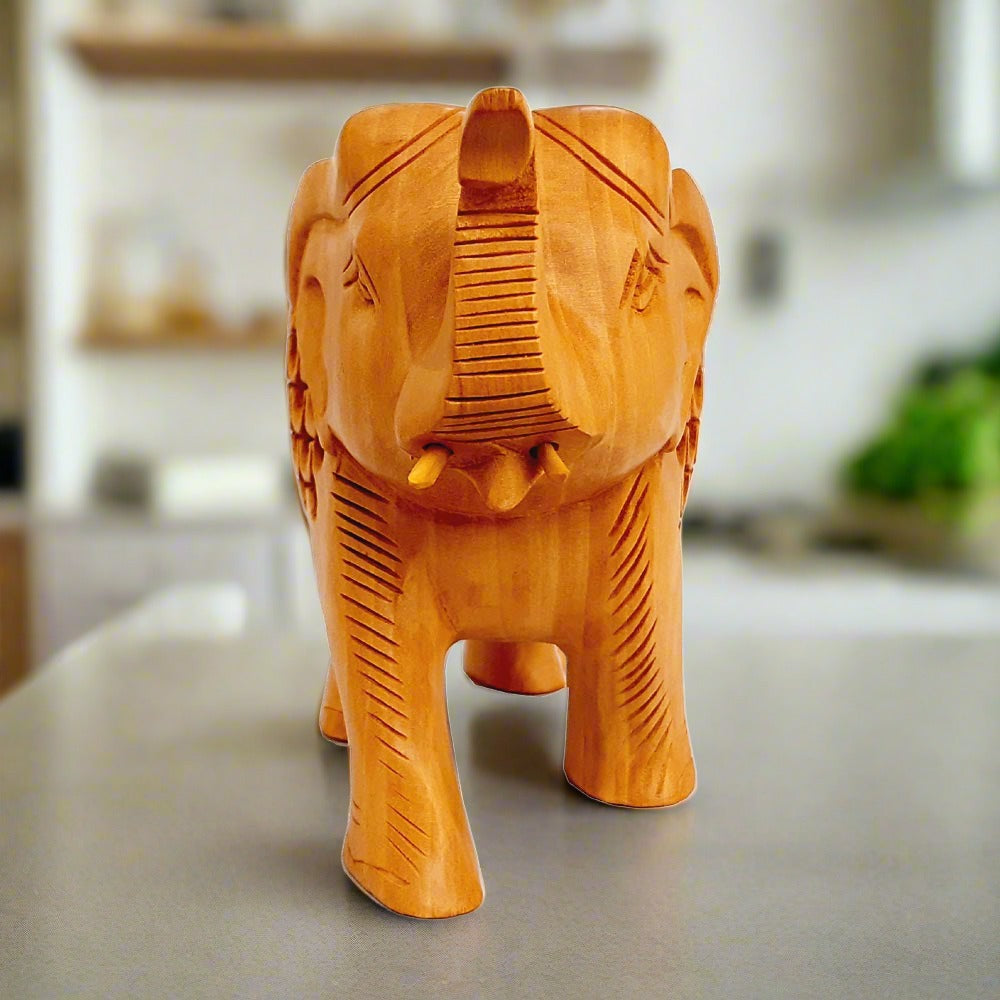 Side view of lucky trunk-up wooden elephant showpiece with intricate wood lattice patterns.