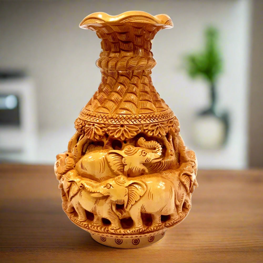 Handcrafted Kadamba wood flower pot with multiple elephant carvings front view.