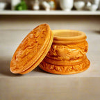 A handmade round powder box made of good quality Kadamba wood with bangle cut-threading on the lid.