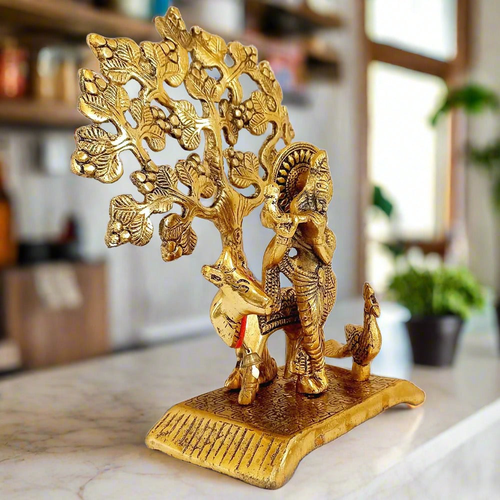 Exquisite metal Lord Krishna statue with cow, peacock & tree – perfect home altar display.