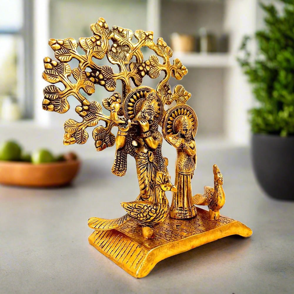 Magnificent golden metal Radha Krishna idol with tree & peacocks – 20x15x9cm divine love showpiece.