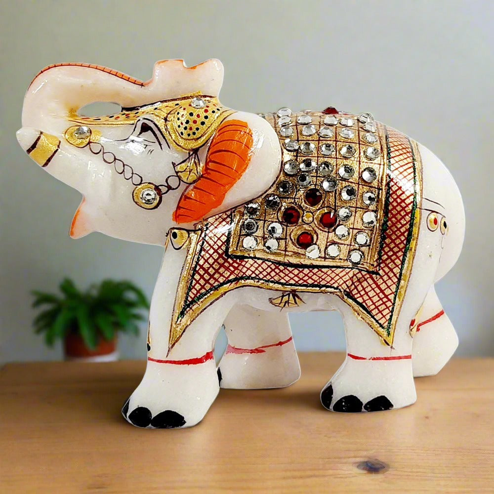 Closeup of hand-studded white red kundan on gorgeous marble elephant idol.