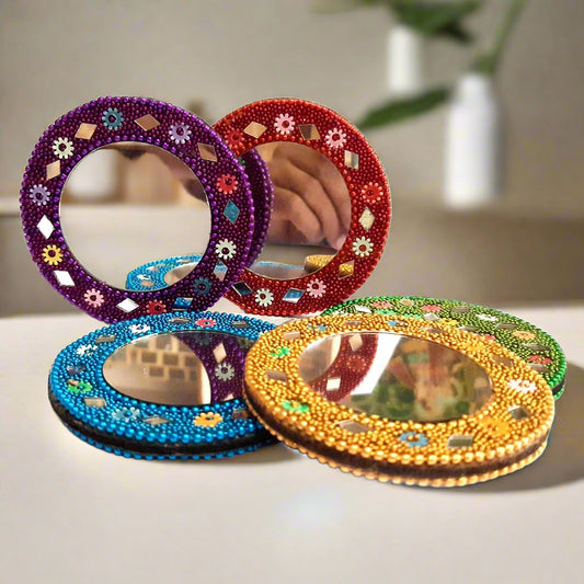 A beautiful lakh work makeup mirror, a very popular return gift for women during weddings and festivals.