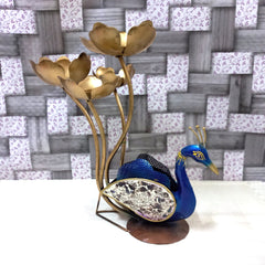  Large metal peacock showpiece with intricate hand painting and glass pieces on feathers, holding four lotus candles.

