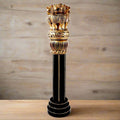 Large wooden Ashoka pillar decorated with golden brass color and lion heads, national symbol of India