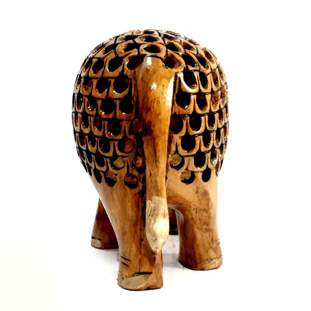 Back of intricate undercut lattice carving on oxidized wooden elephant.