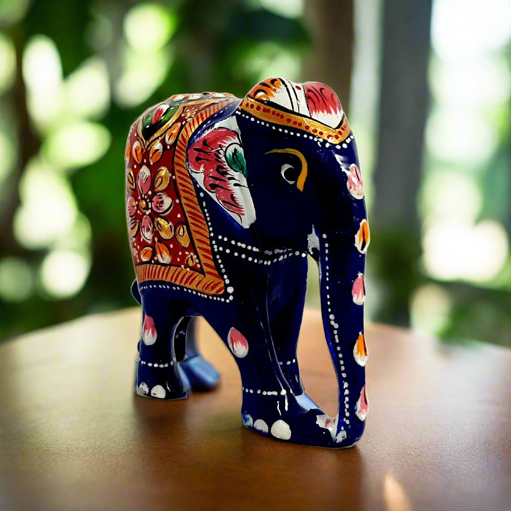 A wooden elephant with a low trunk and beautiful floral design Meenakari painting.