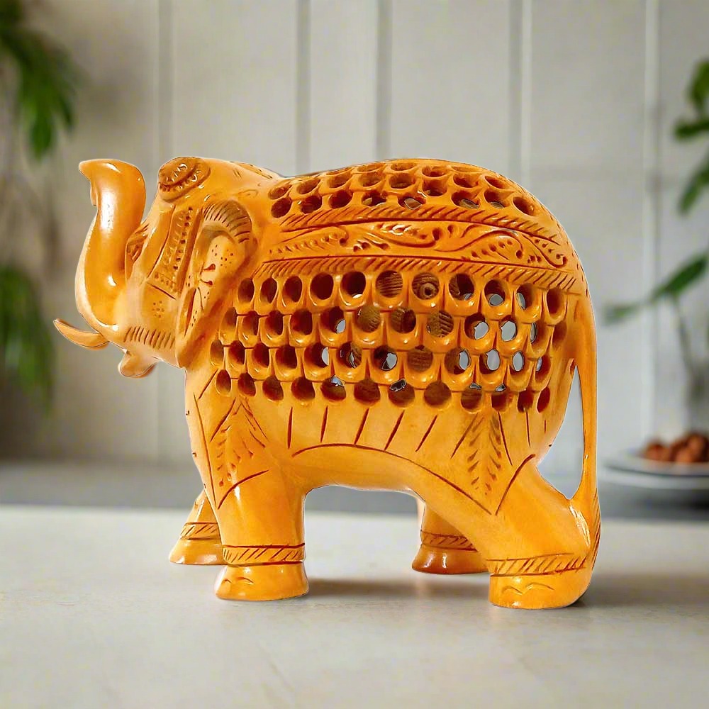 A beautiful carved wooden lucky elephant with its trunk up, featuring intricate carvings.