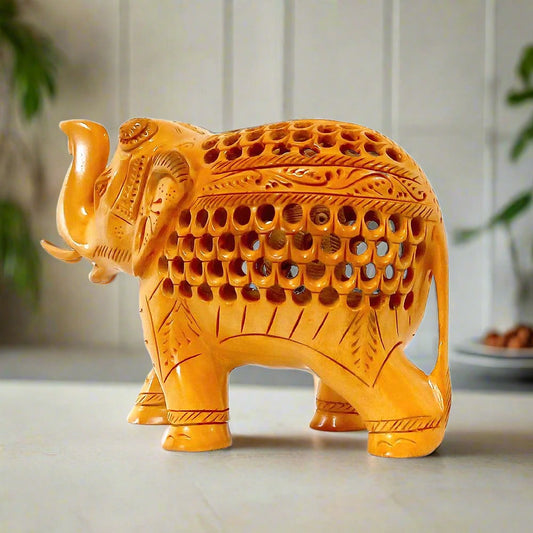 A beautiful carved wooden lucky elephant with its trunk up, featuring intricate carvings.
