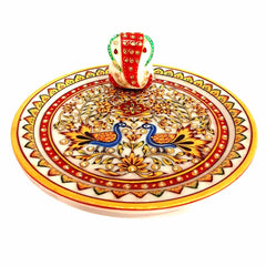 Close-up center detail showing marble Ganesha idol on hand-painted worship plate
