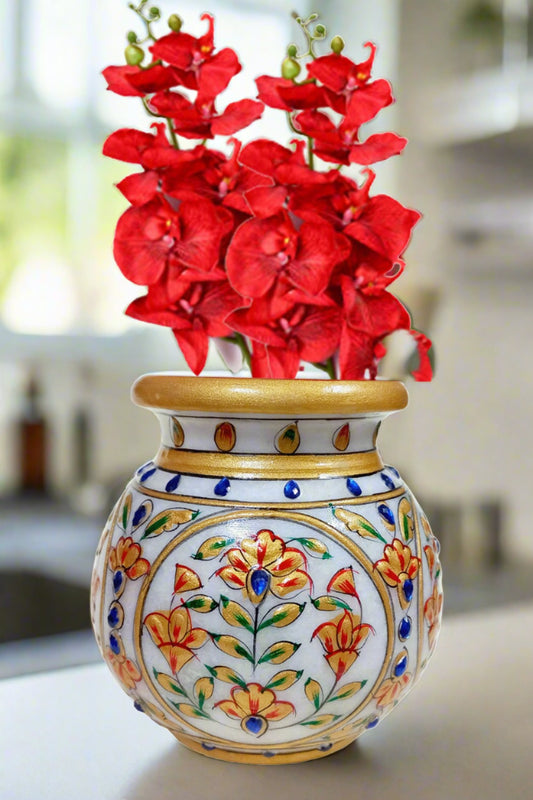 A decorative round marble pot used for holy water (Gangajal) or as a flower vase.