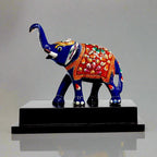 Hand-meenakari blue metal elephant statue on wood base front view.