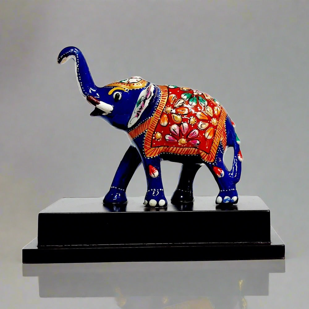Hand-meenakari blue metal elephant statue on wood base front view.