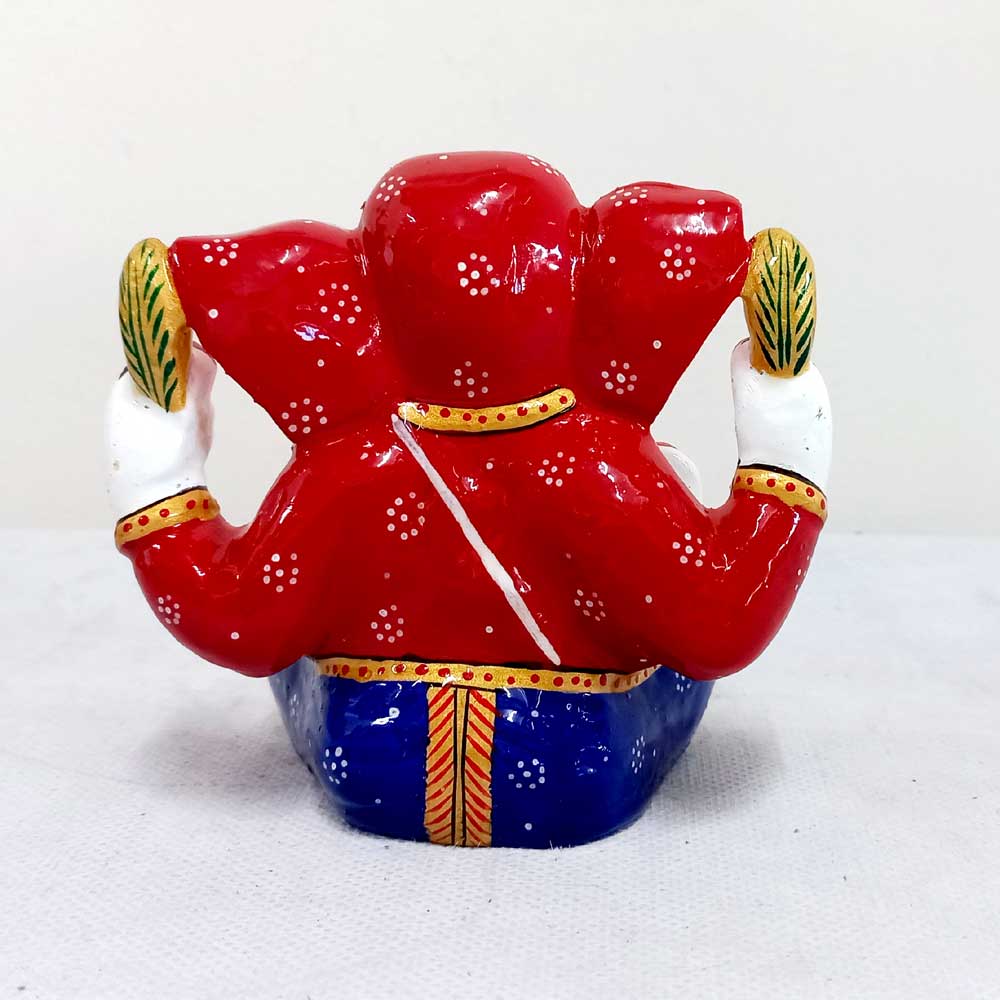 Handcrafted Ganesha idol with vibrant meenakari painting, holding laddoos and giving blessings, suited for worship