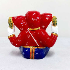 Handcrafted Ganesha idol with vibrant meenakari painting, holding laddoos and giving blessings, suited for worship