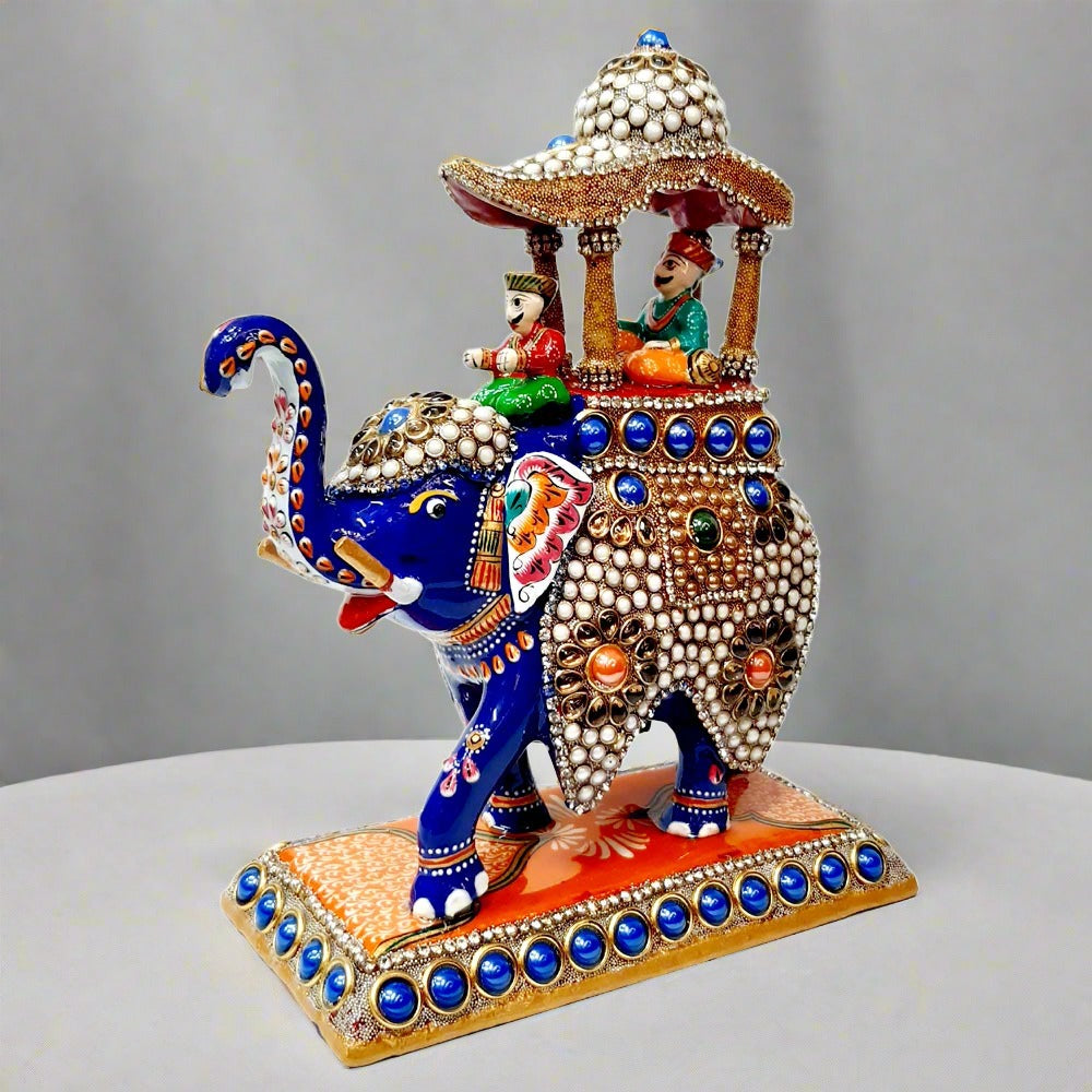 Detailed metal Ambabari elephant decorated with meenakari painting and studded with stones, crafted for regal display.