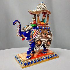 Detailed metal Ambabari elephant decorated with meenakari painting and studded with stones, crafted for regal display.