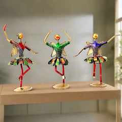 A hand-painted metal dancing dolls set of 3, perfect for home decor.
