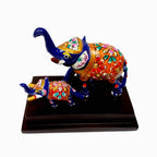 Metal elephant pair with traditional Meenakari art on a wooden base.