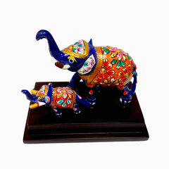 Metal elephant pair with traditional Meenakari art on a wooden base.