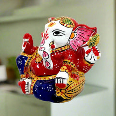 Metal Ganesha idol adorned with vibrant meenakari hand painting, ideal for car decoration