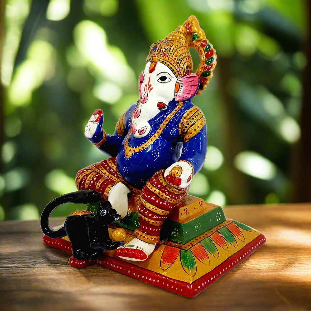 Metal Ganesha idol featuring meenakari painting, blessing hand, laddoos, and rat figure, ideal for puja and car decor