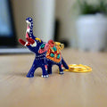 A metal Meenakari elephant keychain with a high trunk, considered a symbol of good luck.