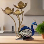 Metal peacock showpiece and candle holder with hand painting, decorated feathers with glass pieces, featuring four lotus-shaped candle stands.