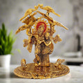 Metal Radha Krishna idol in gold oxidized finish, depicting Radha and Krishna standing together under a tree