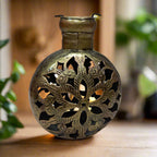 A beautiful metal T-light candle holder with a stunning mesh design and golden oxidized painting.