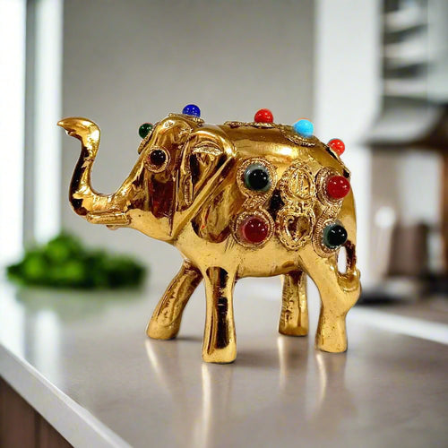 Handcrafted mini brass lucky elephant with raised trunk and stone decoration, 5cm Vastu home decor.