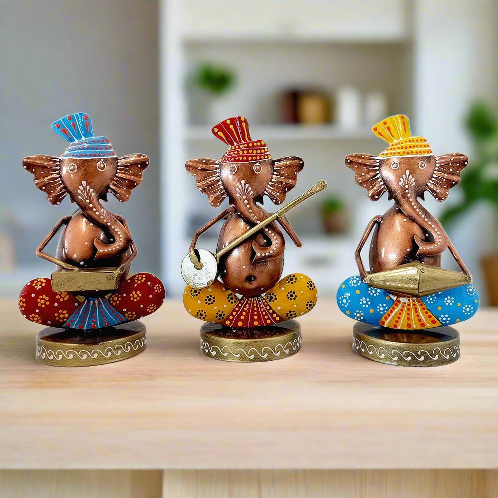 A set of 3 hand-painted metal Musician Ganesha idols playing tabla, sitar, and piano.