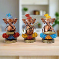 A set of 3 hand-painted metal Musician Ganesha idols playing tabla, sitar, and piano.